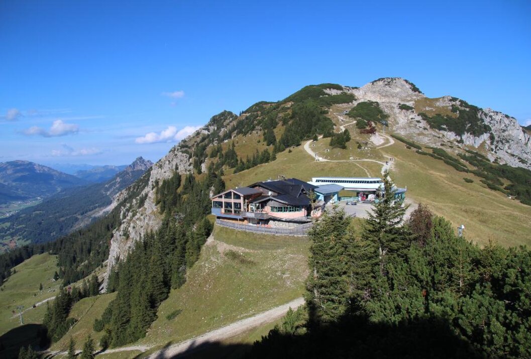 Berglandschaft mit Gebäude auf einem Gipfel unter blauem Himmel